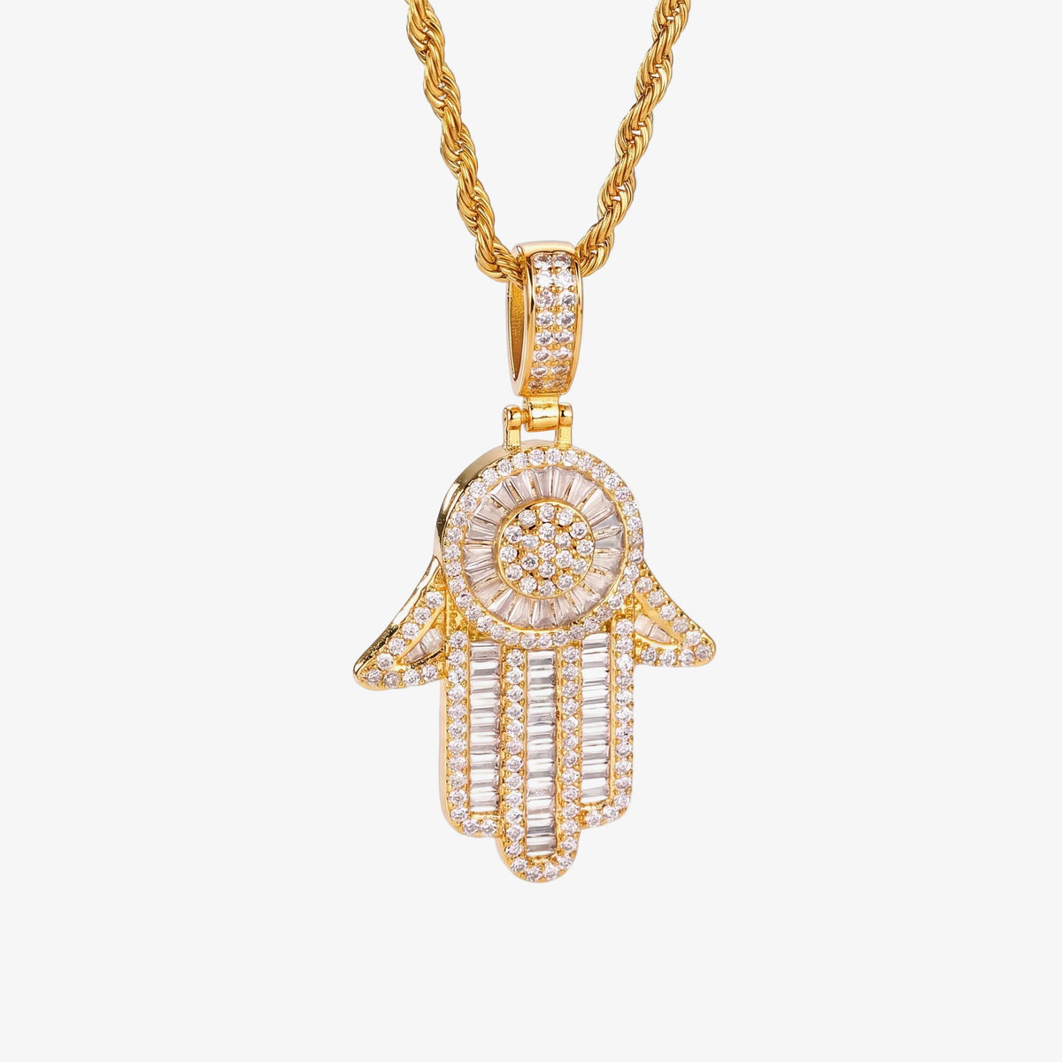 A gold Hamsa hand pendant necklace encrusted with clear cubic zirconia, suspended from a gold rope chain on a white background.