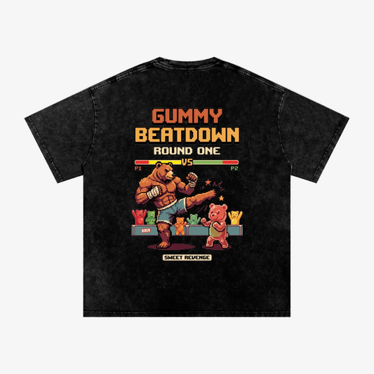 A black acid-wash t-shirt featuring a retro video game-style graphic on the back. The graphic depicts a brown bear fighting a pink bear under the text 'GUMMY BEATDOWN ROUND ONE' and a health bar, with 'SWEET REMEMBER' printed below.