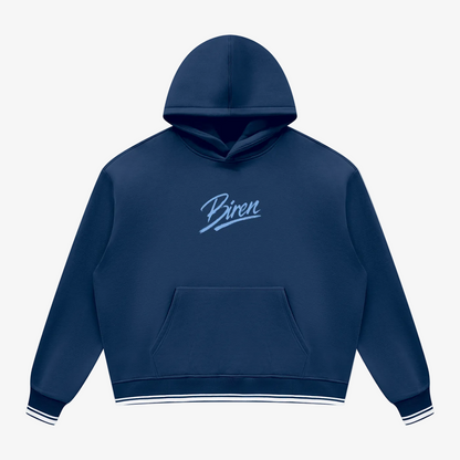 A navy blue pullover hoodie with a kangaroo pocket and a light blue cursive 'Biren' logo on the chest, featuring white and navy striped ribbed cuffs and hem, shown on a plain white background.