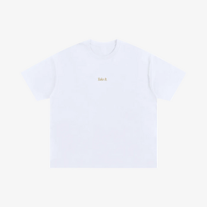 A white short-sleeve crewneck t-shirt with the words 'Take it' printed in a small gold font on the center chest, displayed flat against a solid white background.