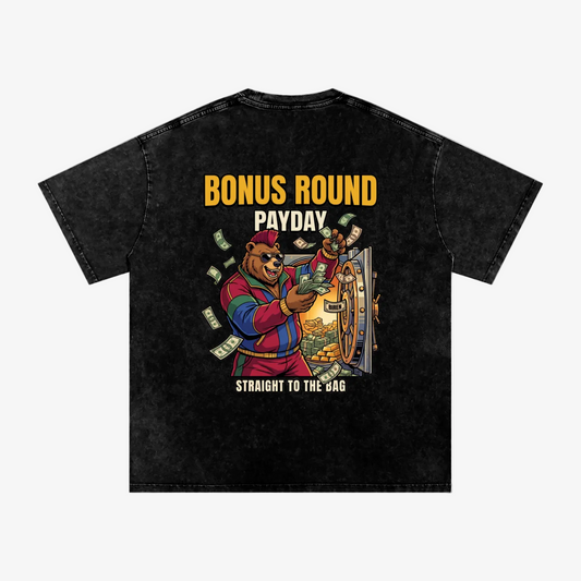 A black acid-wash t-shirt featuring a colorful graphic of a bear counting money with the text 'BONUS ROUND PAYDAY' and 'STRAIGHT TO THE BAG'.