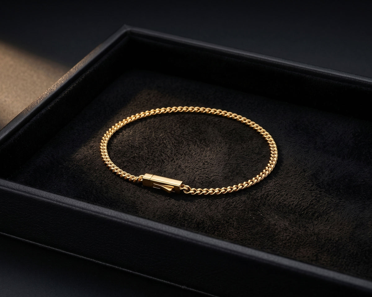 Fine 3mm gold curb chain bracelet in a black jewelry tray with suede lining