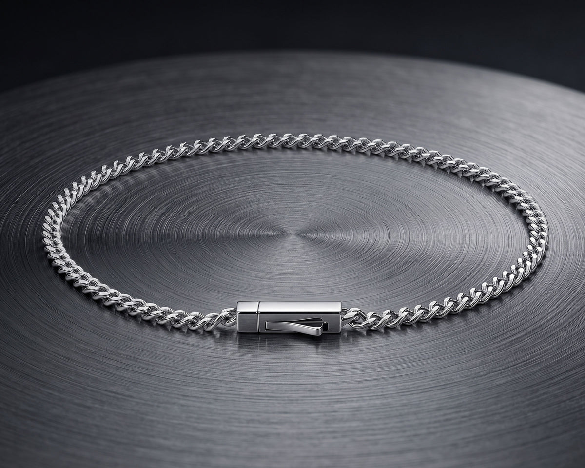 Silver 3mm curb chain bracelet on a dark brushed steel disc