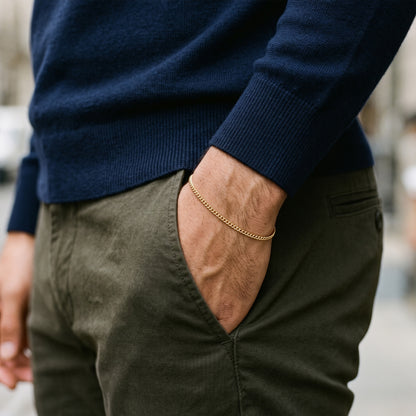 Man wearing a 3mm gold curb chain bracelet, hand in pocket
