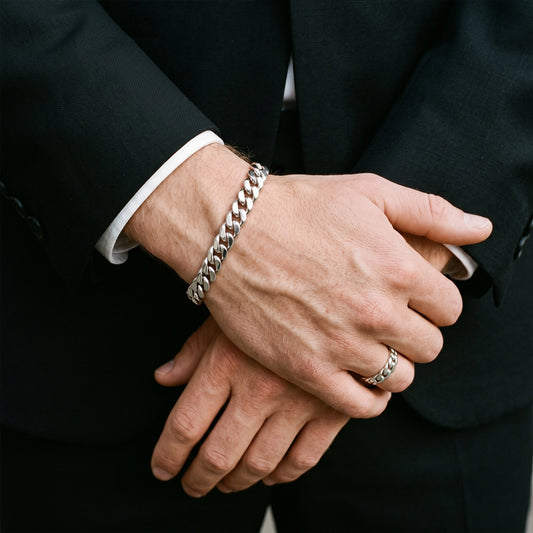 8mm silver curb chain bracelet worn with a black suit and white shirt cuff