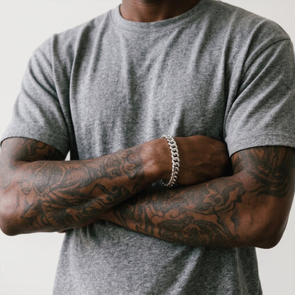 Man in a grey t-shirt with arms crossed, wearing an 8mm silver curb chain bracelet