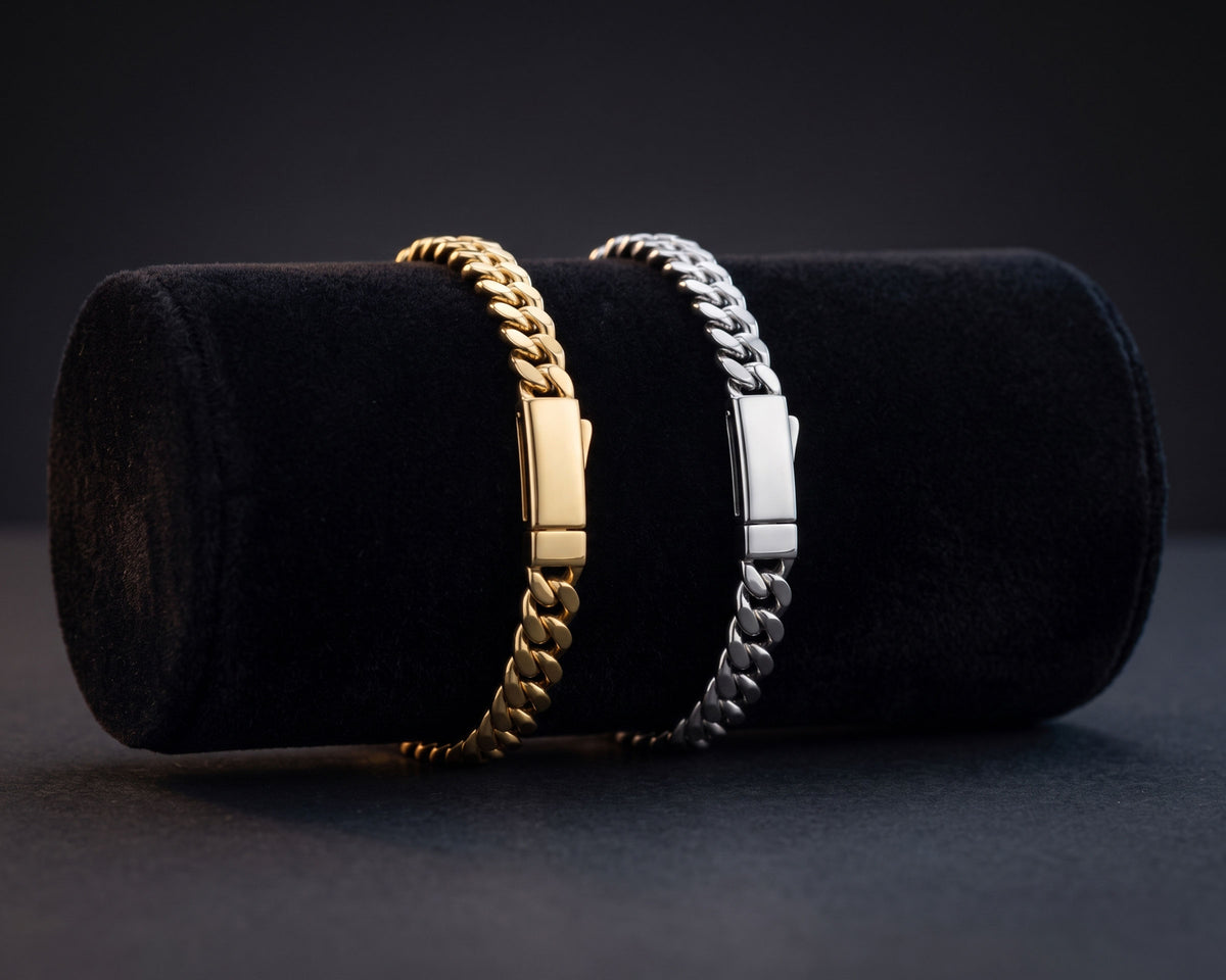 Gold and silver 5mm curb chain bracelets on a black velvet display cylinder