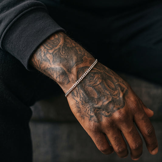 3mm silver Miami Cuban bracelet on a tattooed men's wrist