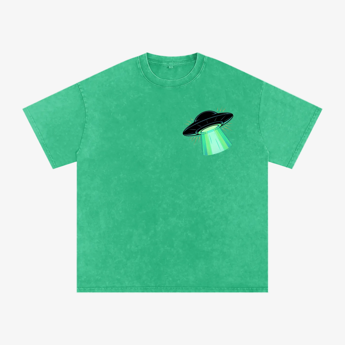 A green short-sleeve crewneck t-shirt featuring a small graphic of a black flying saucer with a glowing green beam on the left chest, displayed on a solid white background.