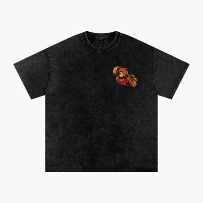A black acid-wash short-sleeve t-shirt with a small cartoon graphic of a bear lifting a barbell on the left chest, displayed on a solid white background.