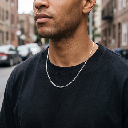 Man wearing a 3mm silver Miami Cuban chain over a black t-shirt