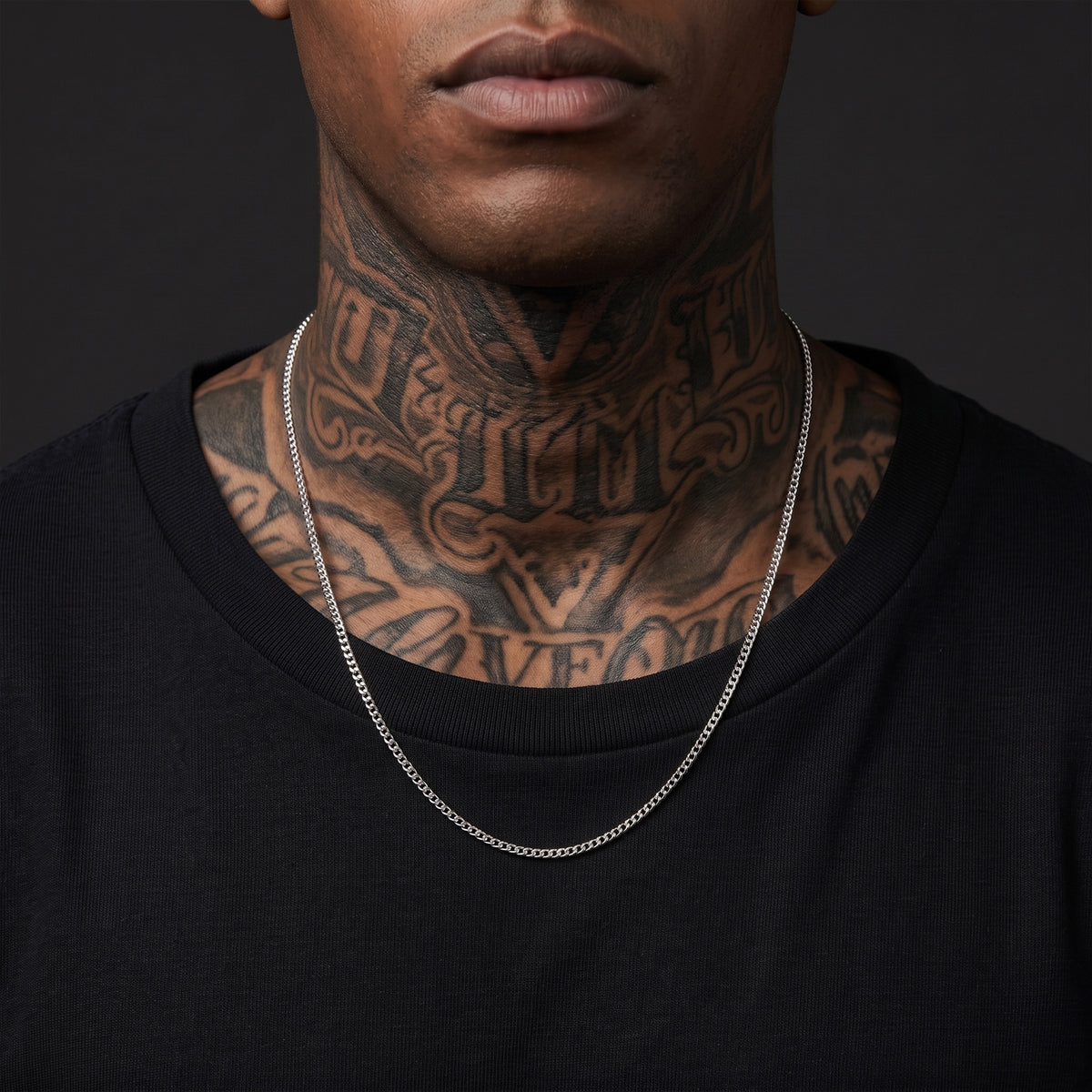 Man with tattoos wearing a 3mm silver Miami Cuban chain