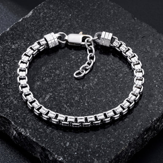 Silver double box chain bracelet on a black stone
